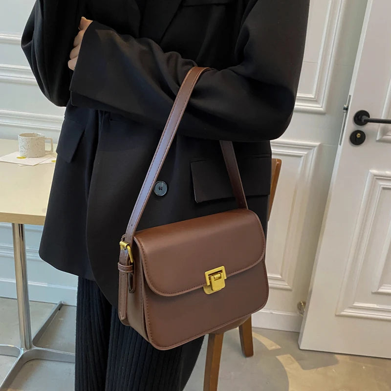 Stylish women's small turn-lock crossbody bag, a compact flap design for modern daily wear.