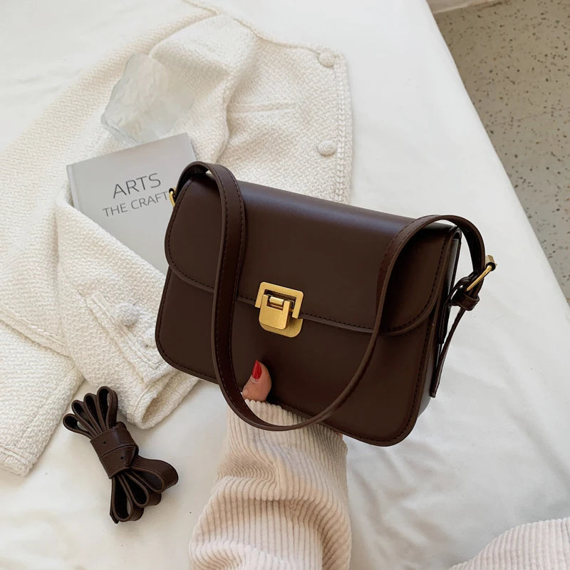 Chic women's small flap crossbody bag with a secure turn-lock closure, perfect for everyday elegance.