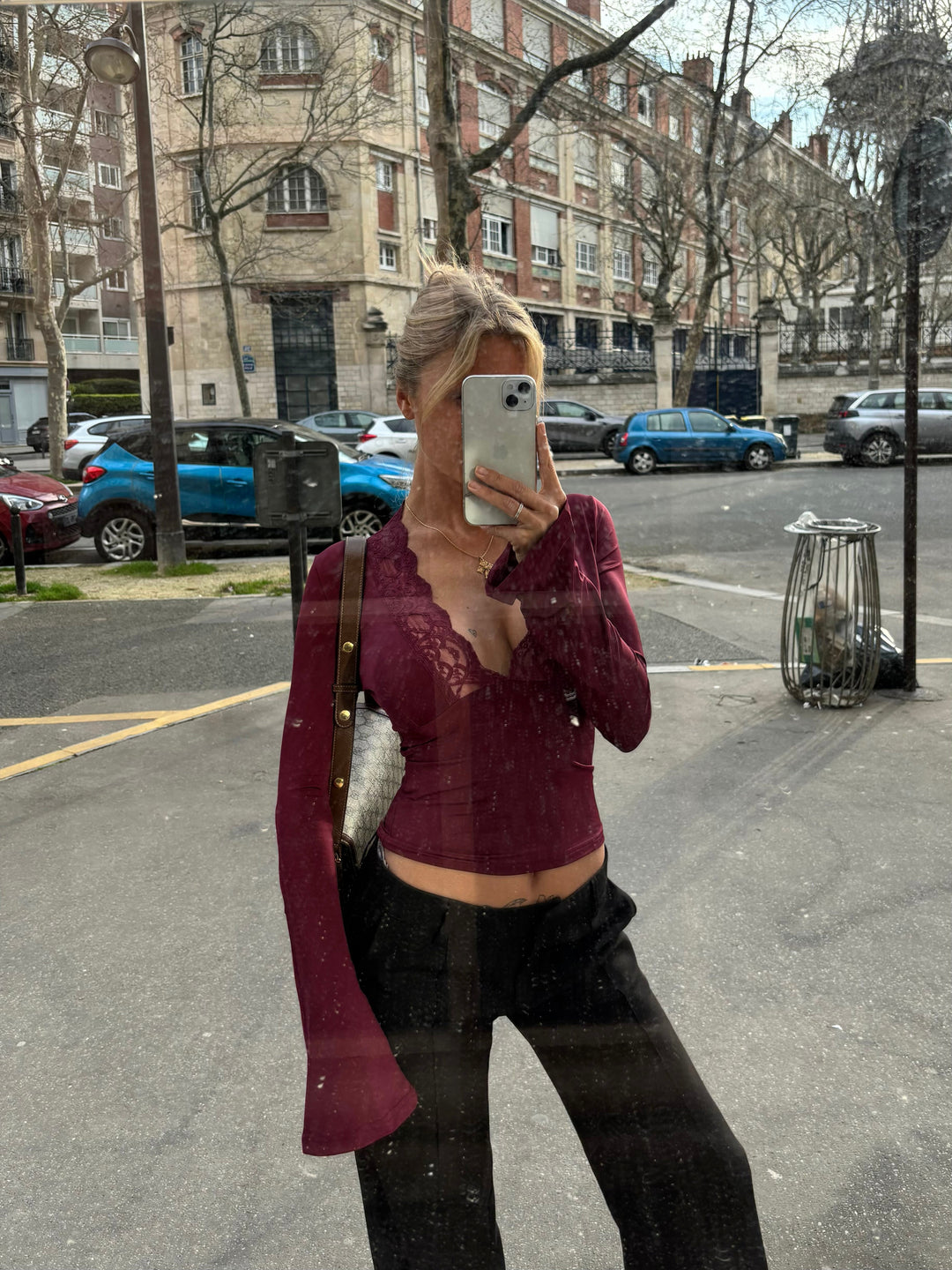 Burgundy deep V women's top featuring unique scallop trim and fashionable flare sleeves. Elegant long sleeve blouse.