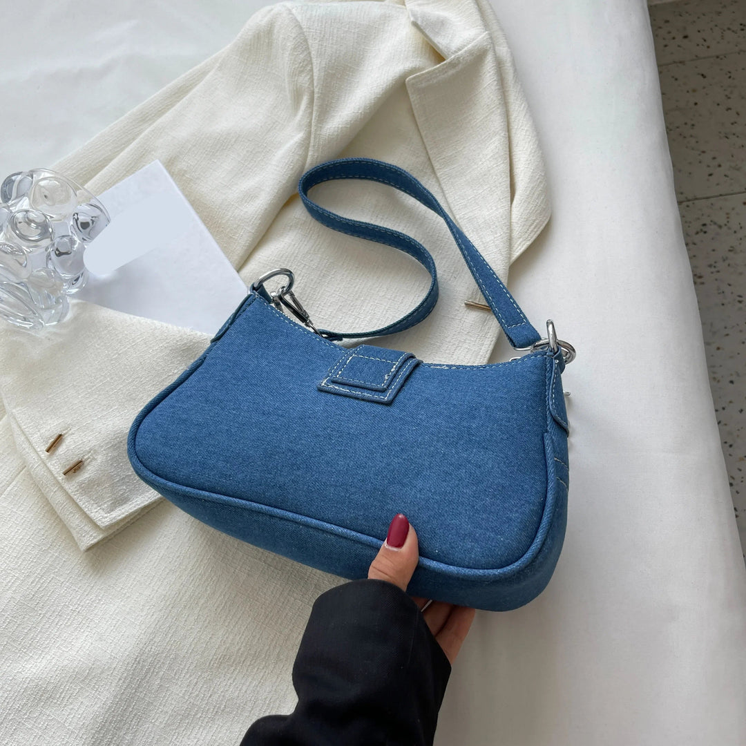 Stylish dark blue women's shoulder bag with secure buckle. Perfect versatile everyday accessory.