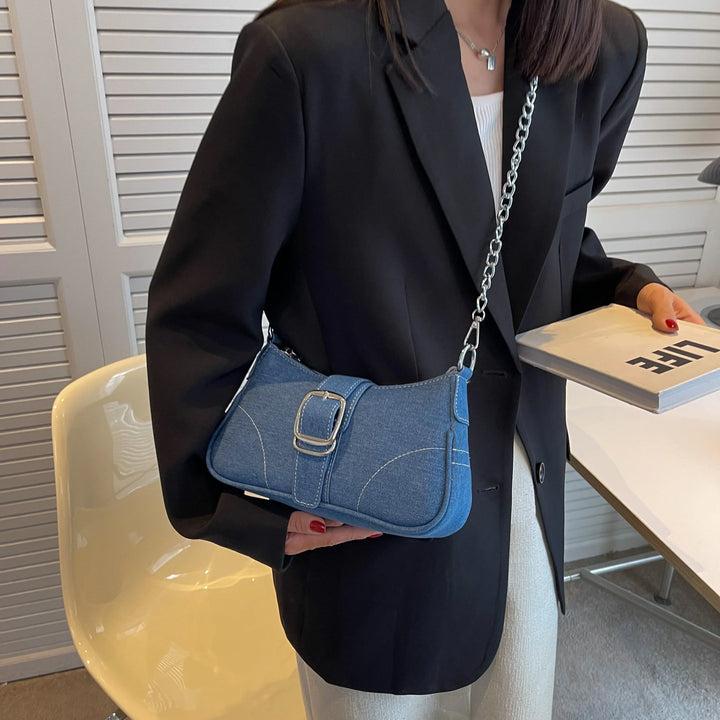 Women's versatile dark blue shoulder handbag featuring a decorative buckle. Ideal for daily essentials.