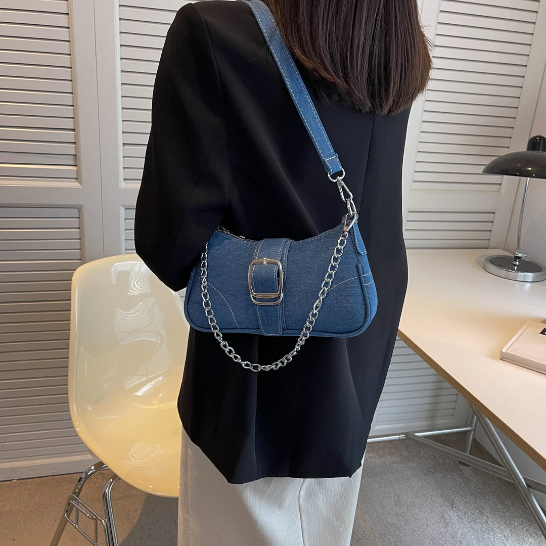 Elegant dark blue women's versatile shoulder bag with a distinct buckle detail. Fashionable handbag.