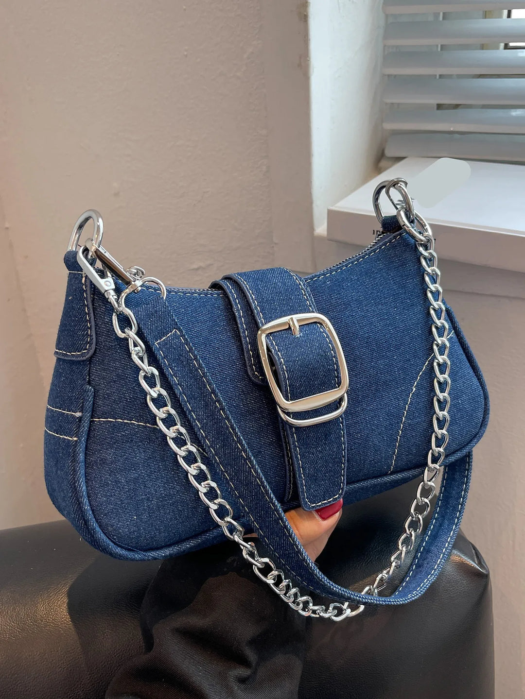 Dark blue women's two-way shoulder handbag with chic buckle closure. Versatile for everyday use.