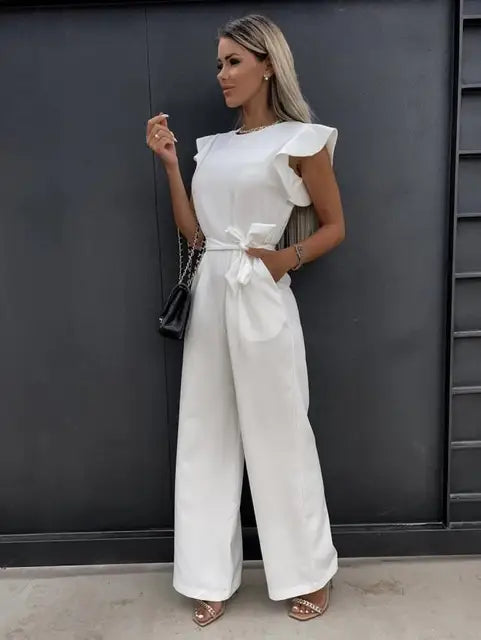 Flowy wide leg women's jumpsuit with elegant flutter sleeves. Versatile formal wear for spring and summer.