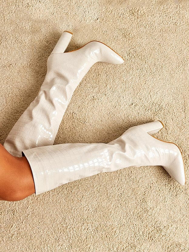 Women's slip-on knee high fashion boots with a trendy pointed toe & stable block heel. Versatile fall/winter footwear.