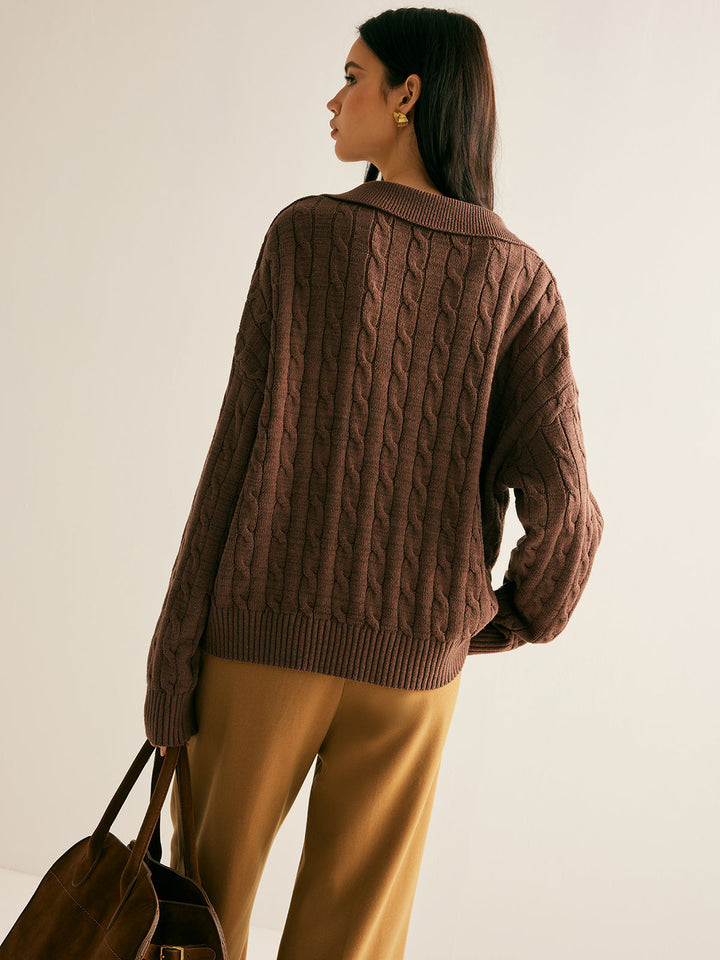 Oversized women's cable knit sweater featuring a stylish collared V-neck, drop shoulder, & cozy knit.