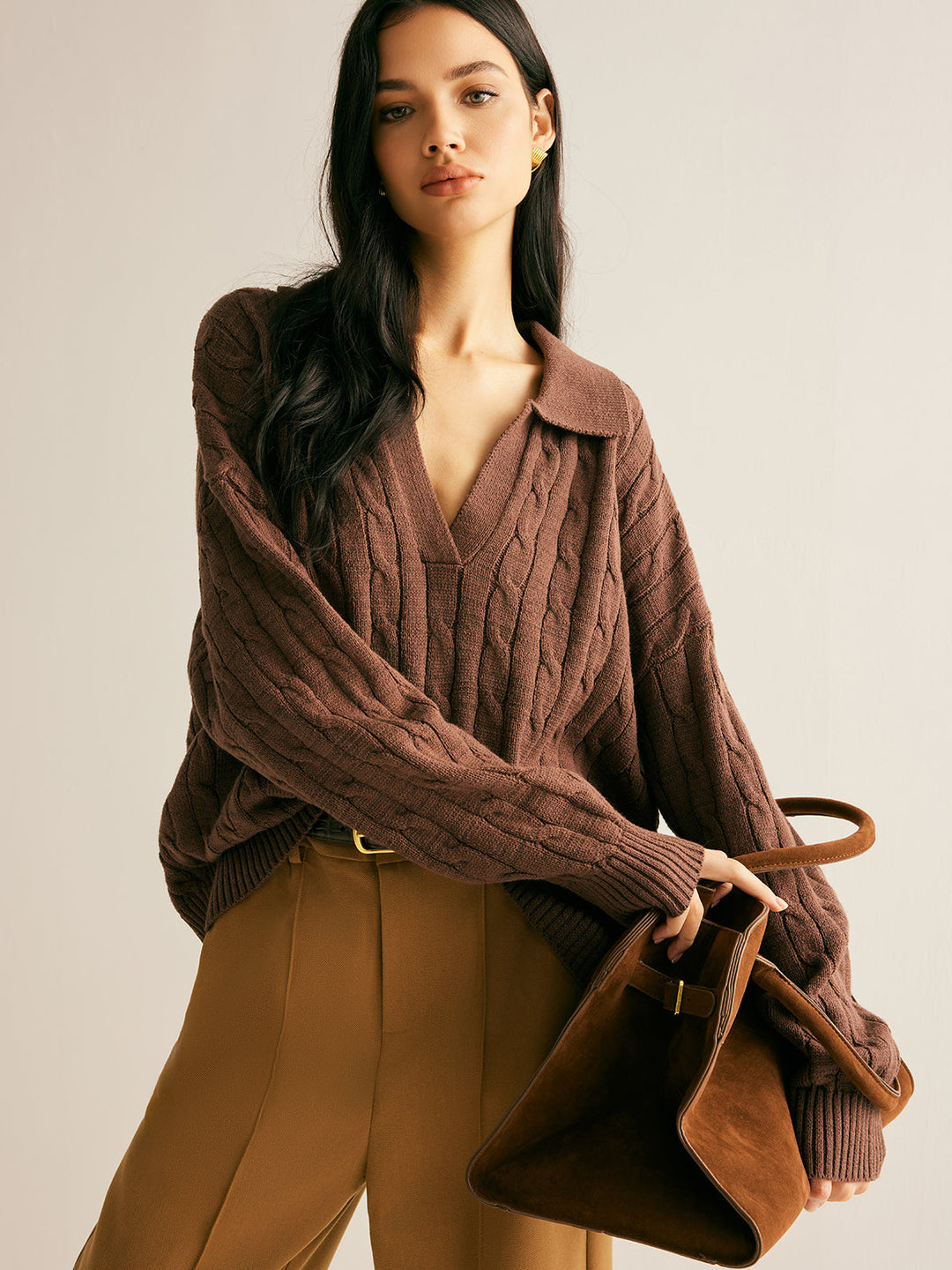 Chunky knitted women's brown jumper, cable knit texture, collared V-neck. Versatile for smart casual winter.