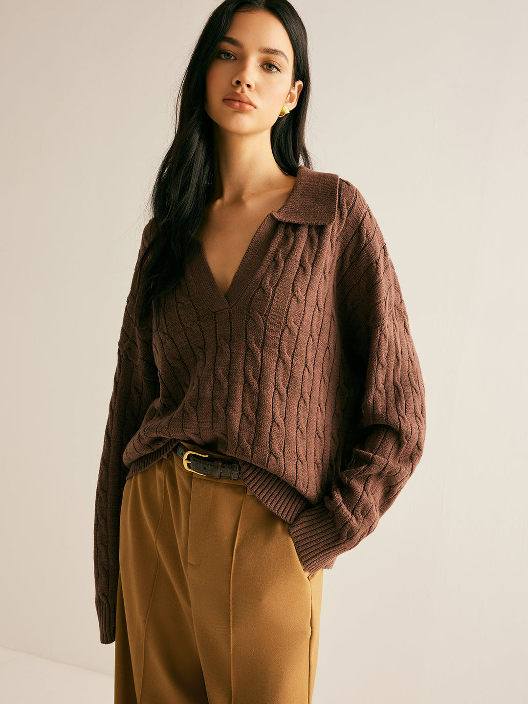 Elegant women's fall/winter cable knit jumper in brown, with a sophisticated collared V-neck design.