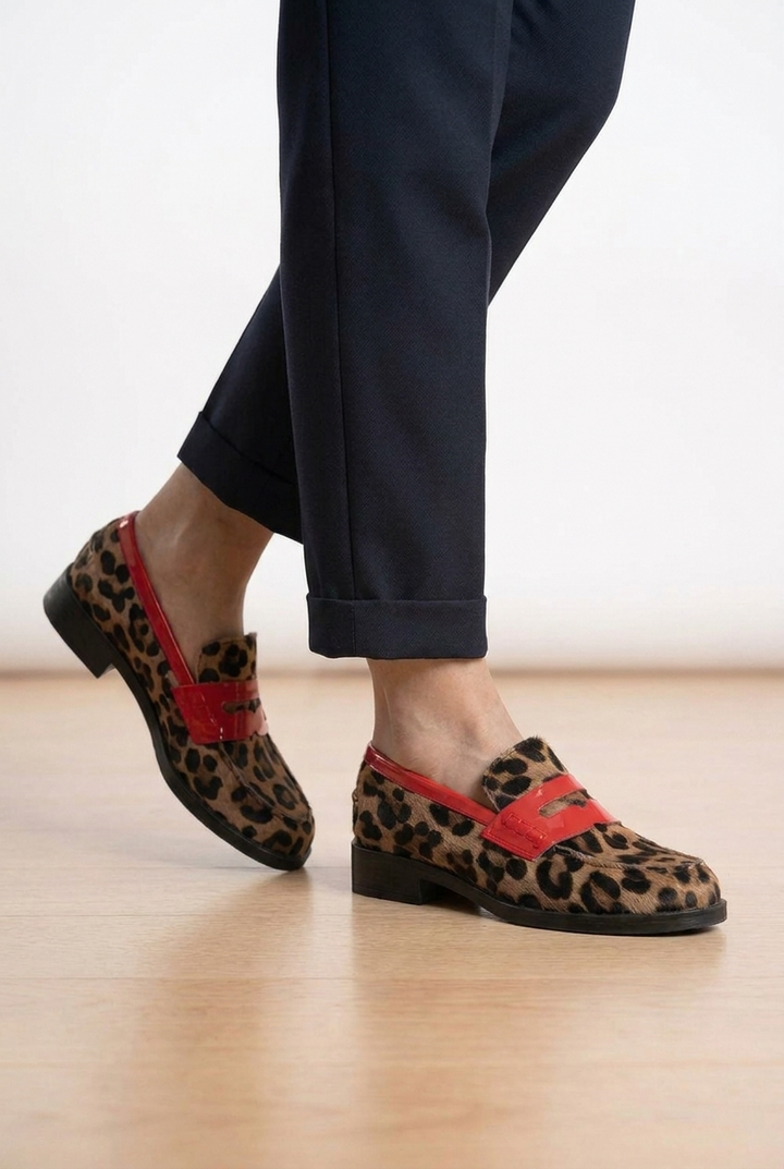 Chunky sole leopard print platform loafers for women. Statement slip-on shoes with a classic penny strap for bold style.