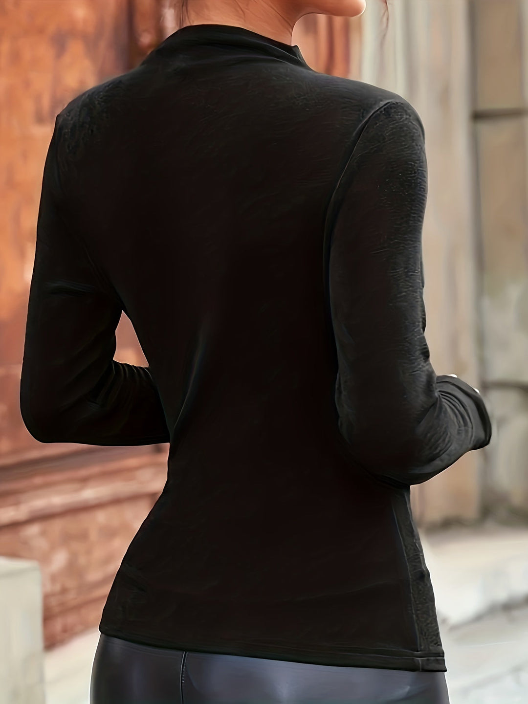 Versatile women's black mock neck long sleeve top with elegant ruching. Stylish and fitted for various occasions.