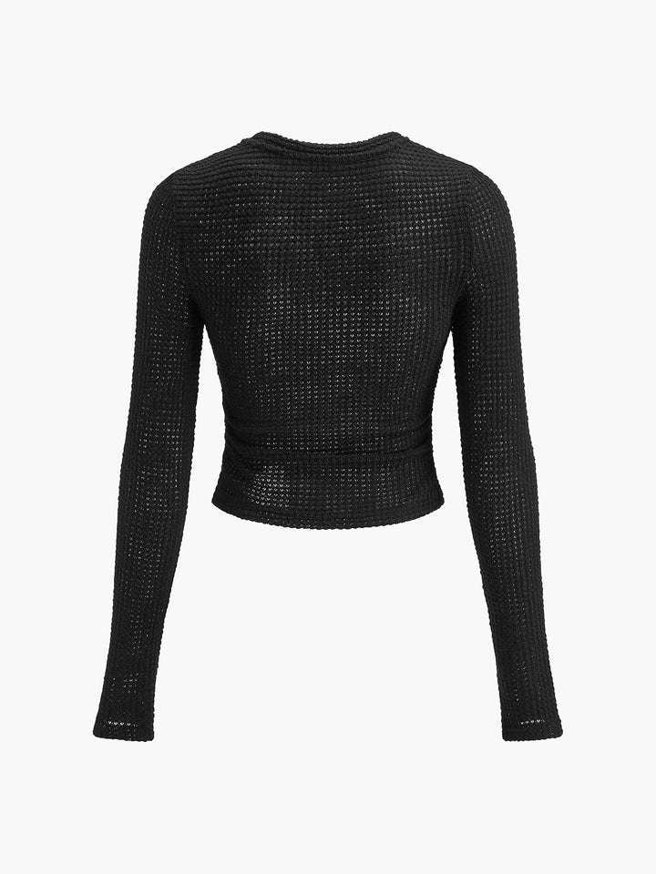 Women's long sleeve top with a textured finish and a sophisticated crew neck.