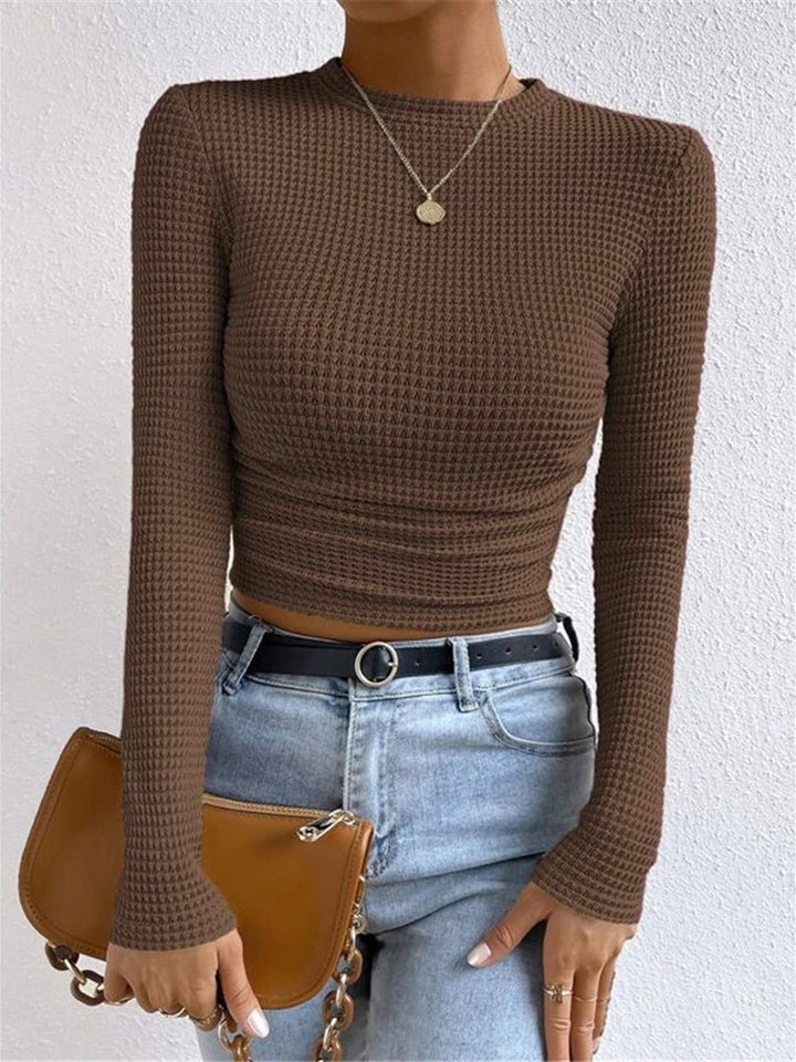 Modern women's textured long sleeve top, offering a chic crew neck style for daily wear.