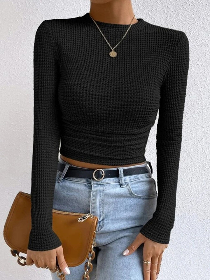 Fashionable women's textured long sleeve top, classic crew neck silhouette.