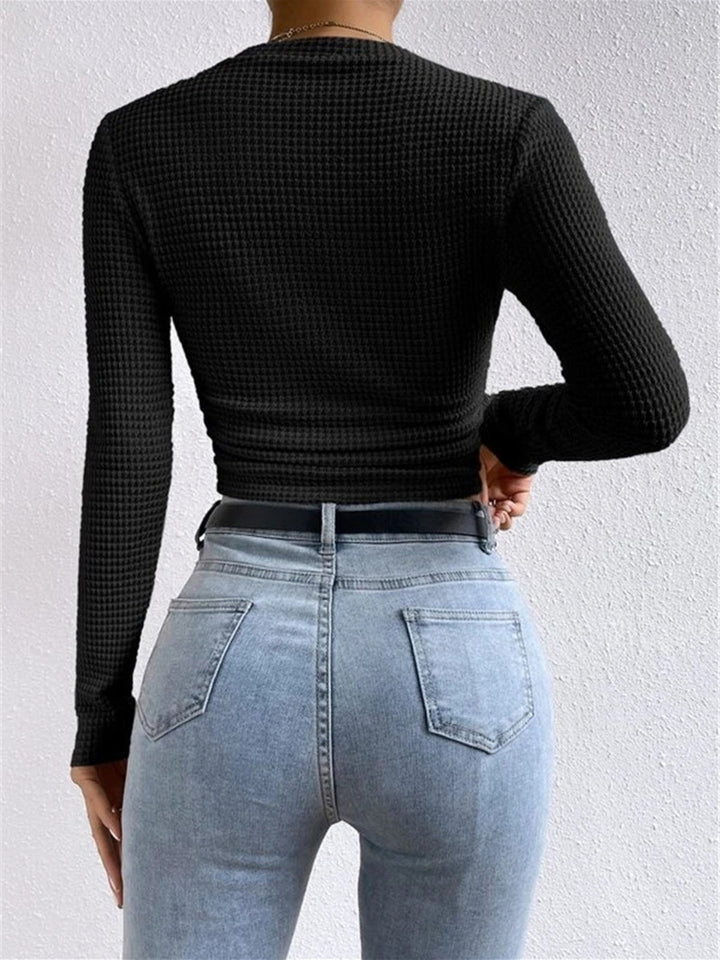 Comfortable women's textured long sleeve top, designed with a versatile crew neck.