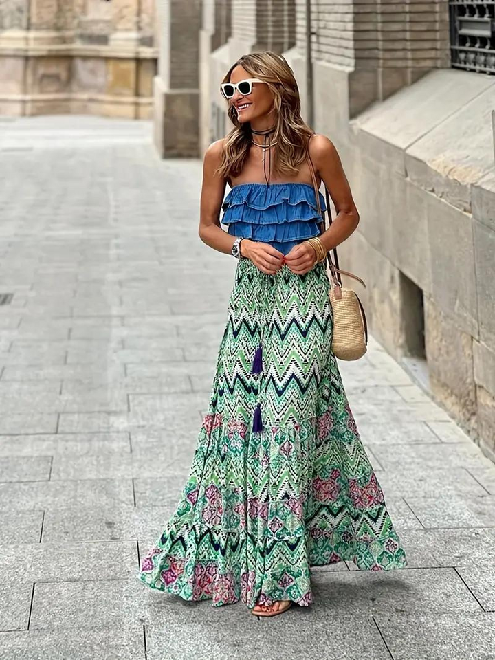 Women's flowing tiered maxi skirt with vibrant print, perfect for summer fashion & boho style.