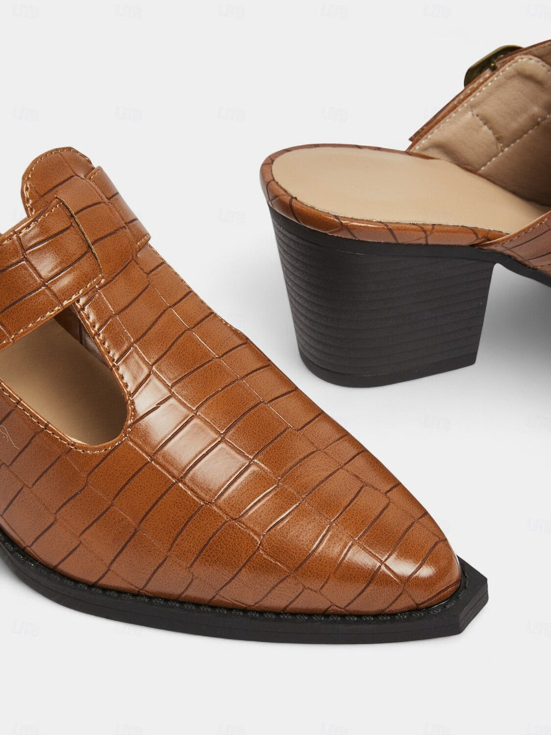 Chic women's mules with a distinctive cut-out design, adjustable buckle, and sturdy block heel. Easy slip-on style.
