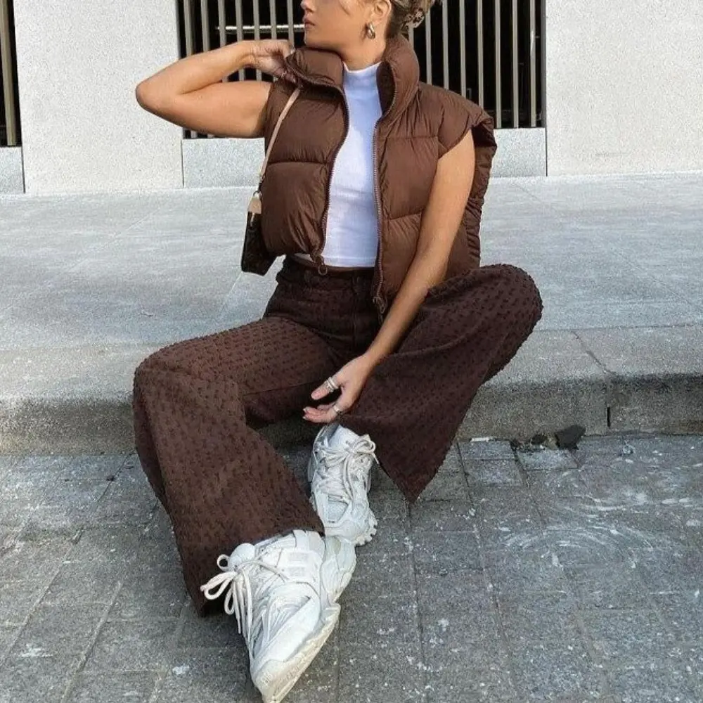 Versatile women's cropped puffer vest with stand collar; a stylish layering piece for fall/winter.
