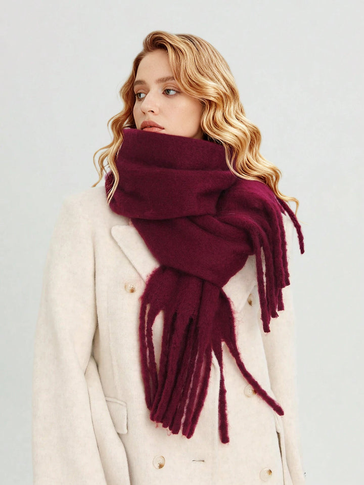 Stylish burgundy oversized women's winter scarf with tassels, a versatile fashion wrap accessory.