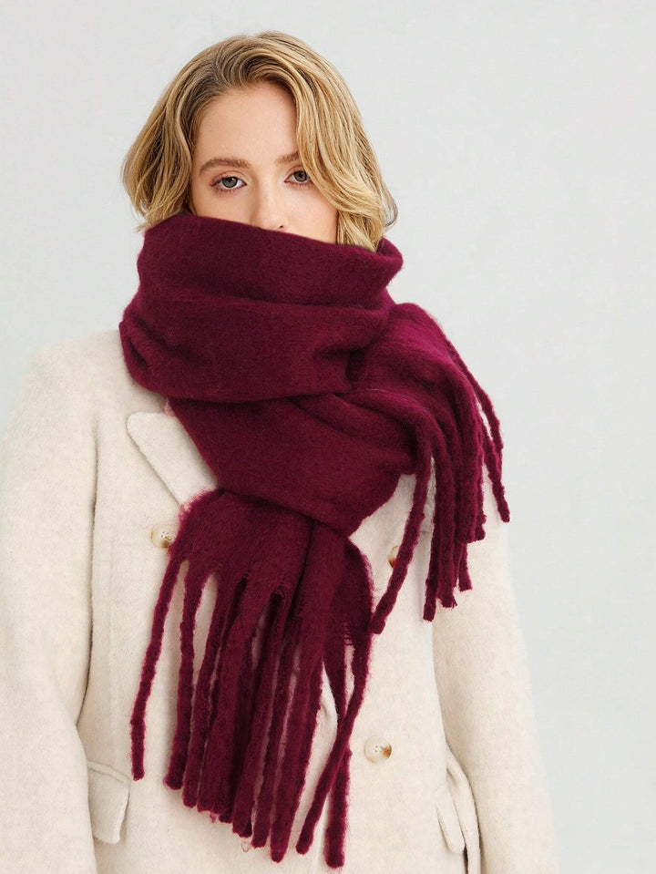 Warm burgundy oversized women's tassel scarf, a cozy winter fashion accessory for ultimate comfort.