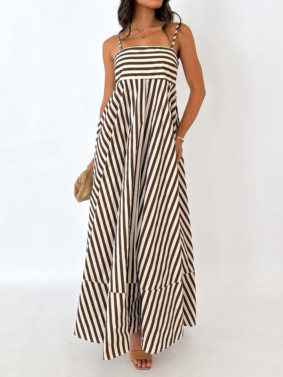 Women's striped maxi sundress, sleeveless & flowing, perfect for summer beachwear or elegant vacation style.