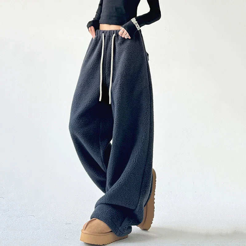 Close-up of women's high waist sweatpants featuring an adjustable drawstring and wide leg for comfort.