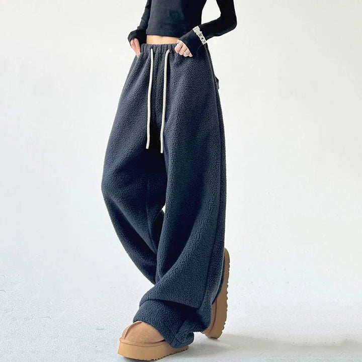 Close-up of women's high waist sweatpants featuring an adjustable drawstring and wide leg for comfort.