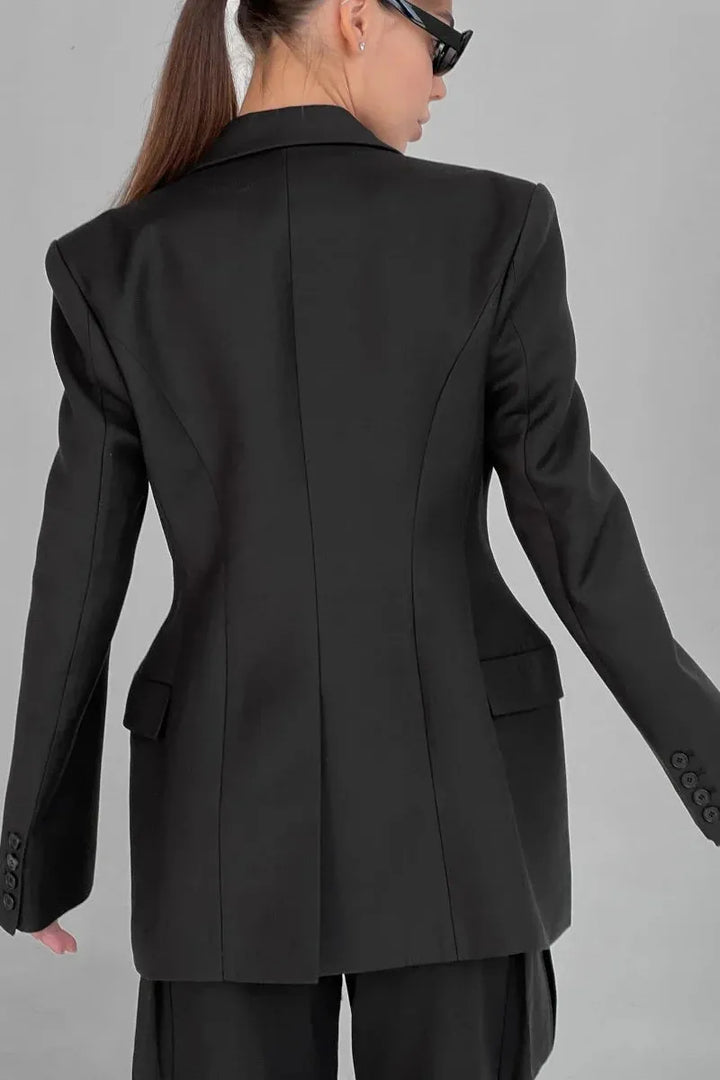 Chic women's tailored blazer with peak lapel, offering elegant outerwear for professional female fashion.