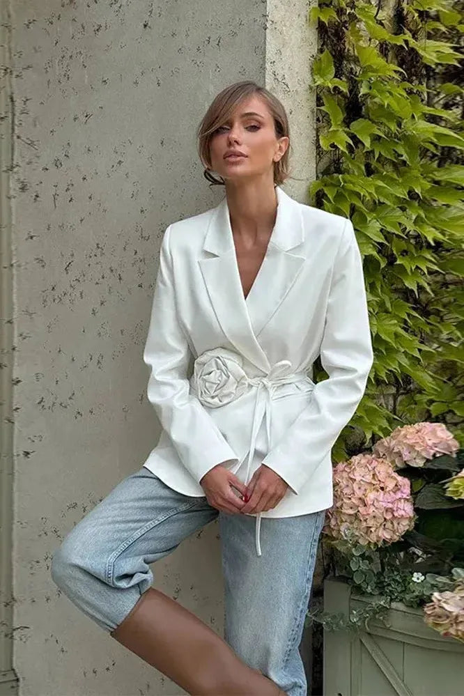 Chic women's tailored blazer featuring a stylish wrap front, rosette, and tie belt. Versatile elegant outerwear.