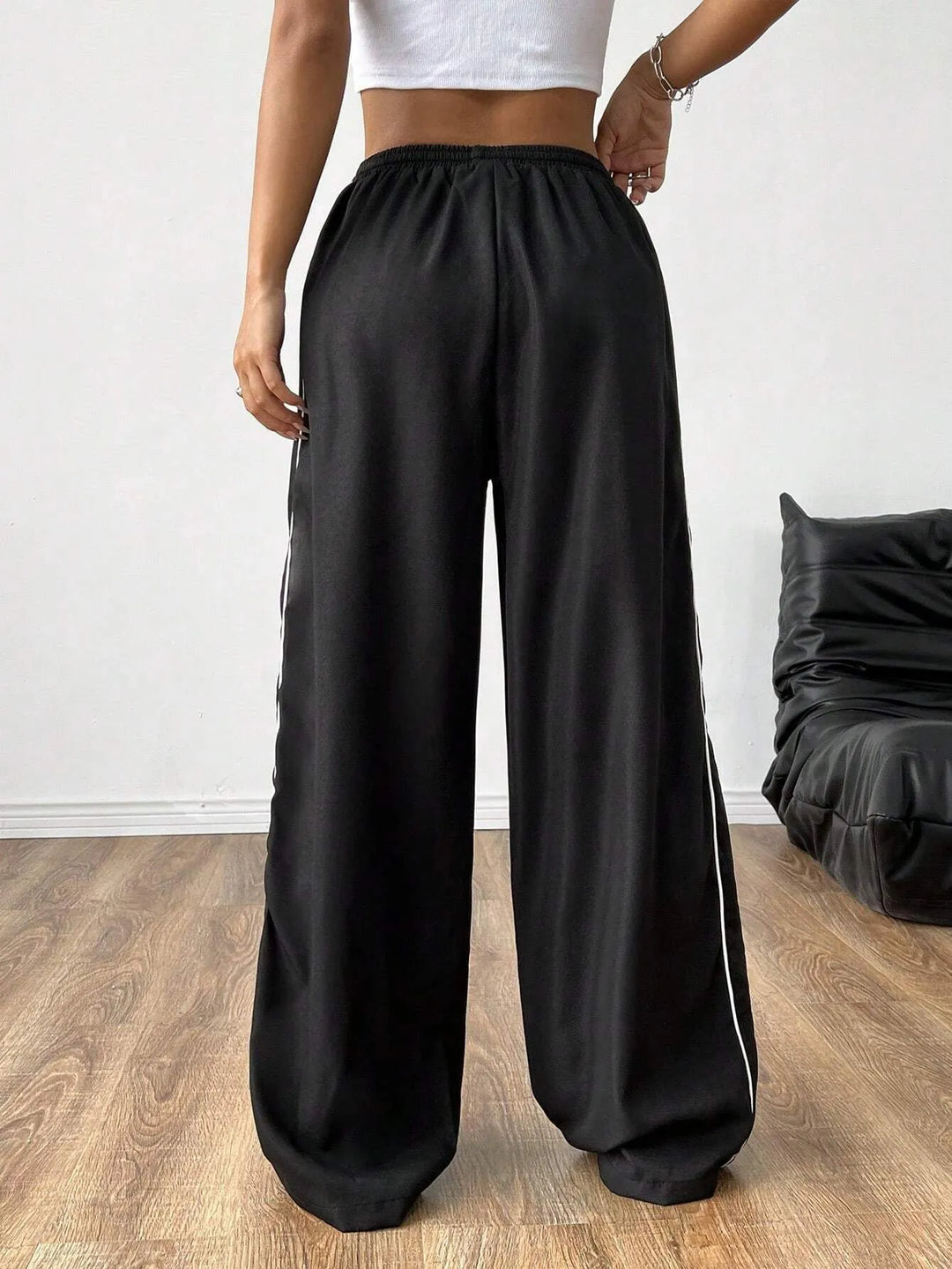 Fashionable women's trackpants featuring a loose fit, practical drawstring waist & distinct side piping detail.