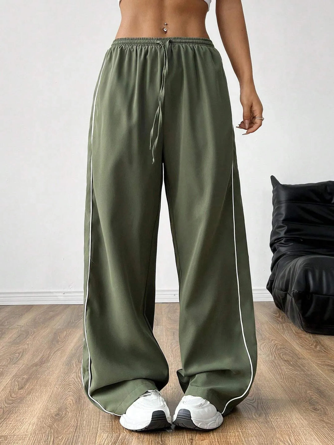 Women's baggy trackpants with drawstring waist & stylish side piping, perfect for casual or athleisure wear.