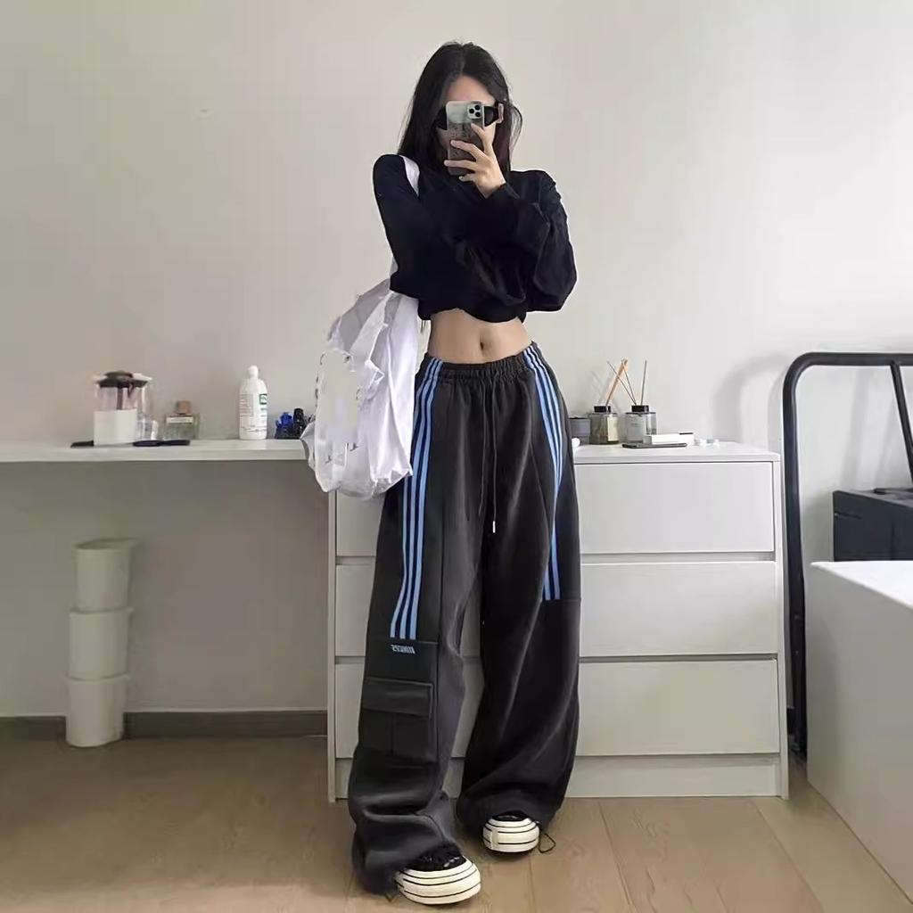 Casual women's baggy cargo trackpants, designed with athletic leisure in mind, featuring trendy side stripes.