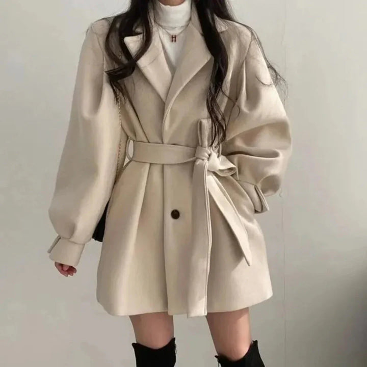 Apricot oversized belted trench coat with lapel & A-line cut. Stylish women's spring/fall jacket.