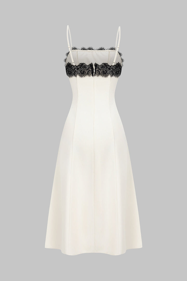 Sleeveless white midi dress featuring delicate black lace, ideal for a chic party or formal event.