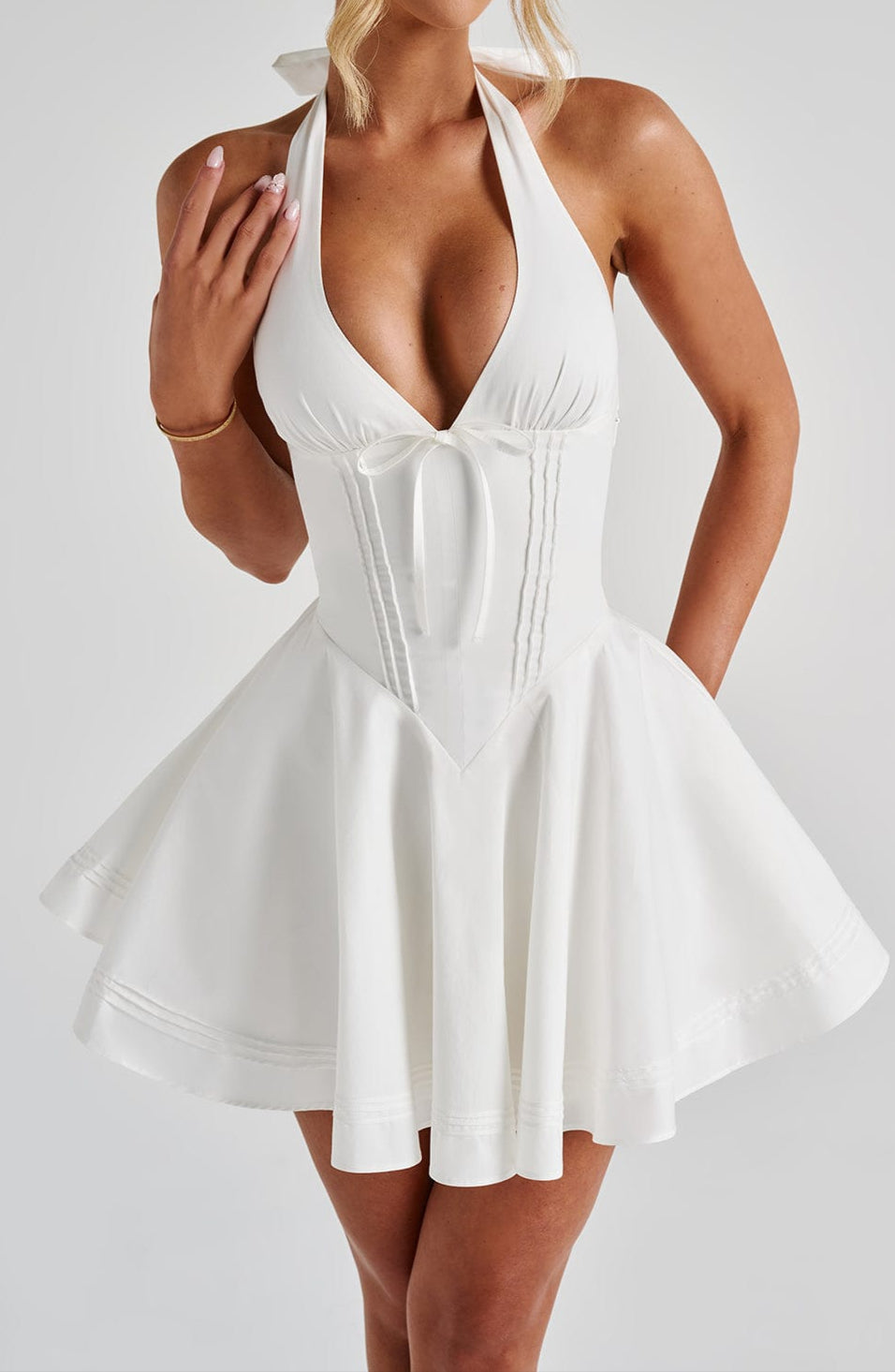 Trendy white mini halter dress for women. A chic fashion choice for any special occasion.