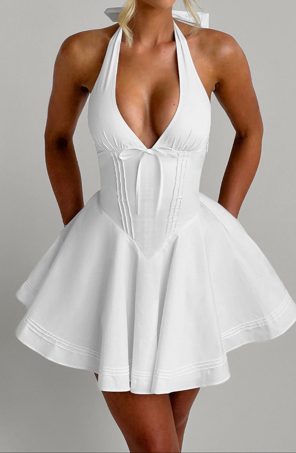 Stunning white sleeveless mini dress, perfect as a chic party or special occasion cocktail dress.