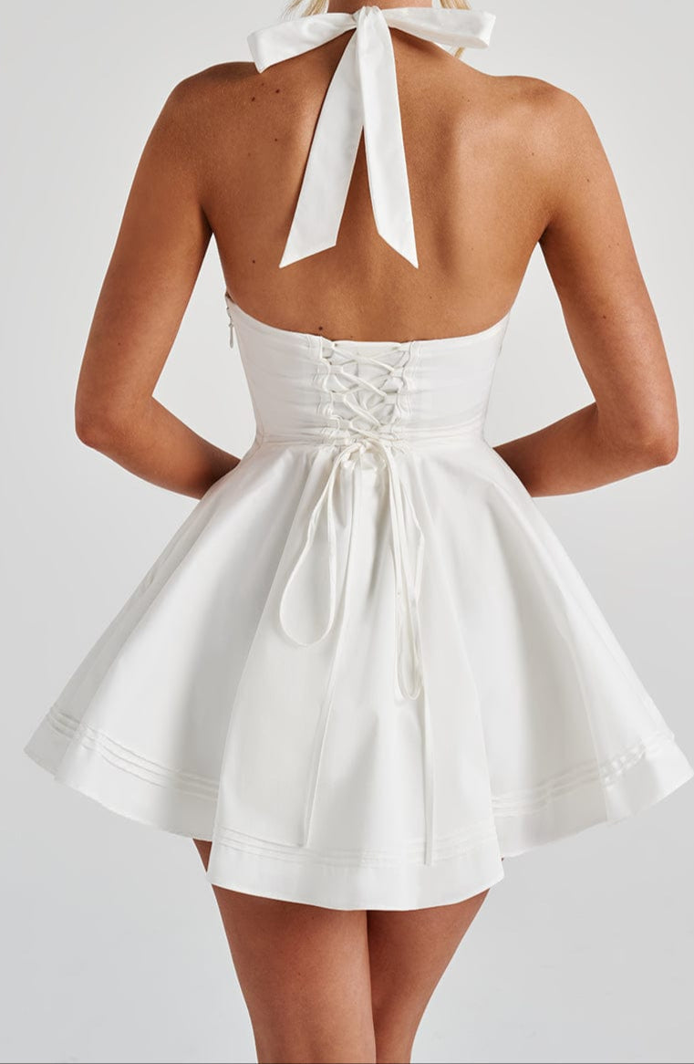 Modern women's white mini halter dress. A chic choice for cocktail parties and evening events.