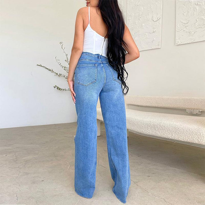 Trendy women's wide-leg jeans, high-rise fit with distressed ripped knees & raw hem. Fashion denim for street style.