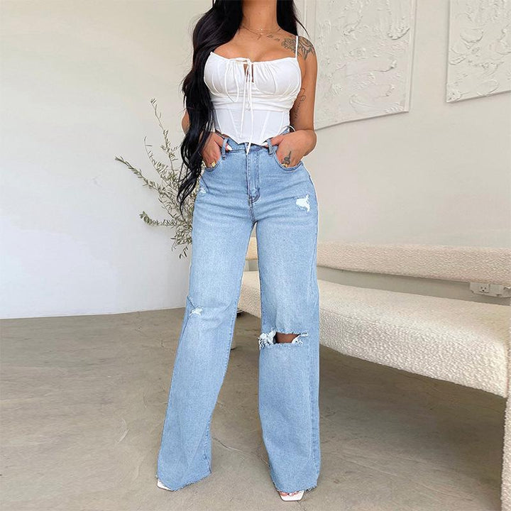 Comfortable high-rise wide-leg jeans for women, featuring chic ripped knees & a modern raw hem. Casual denim pants.