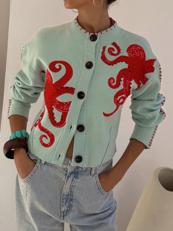 Light green women's cardigan with playful octopus graphic, ideal for casual autumn fashion.