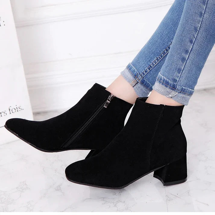 Versatile women's ankle boots with side zipper, perfect for everyday style and comfort, featuring a flat heel.