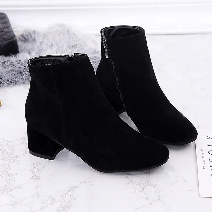 Sleek women's ankle boots with a practical side zipper, comfortable flat heel, ideal for chic and versatile wear.