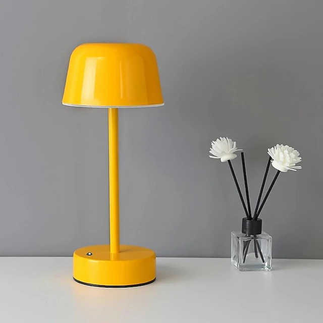 Dimmable modern LED table lamp, cordless, perfect portable light for various home decor settings.