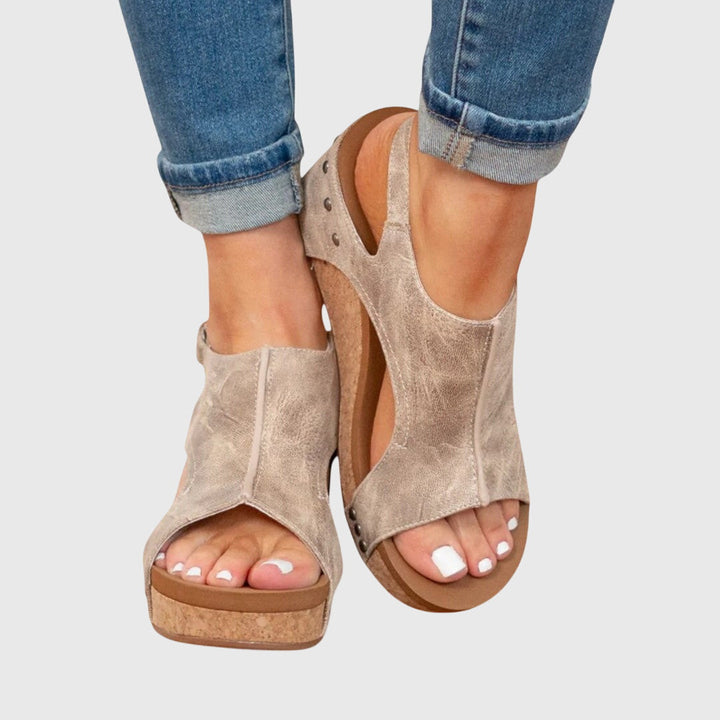 Elegant women's wedge sandals with an open toe and adjustable fit, perfect for summer style.
