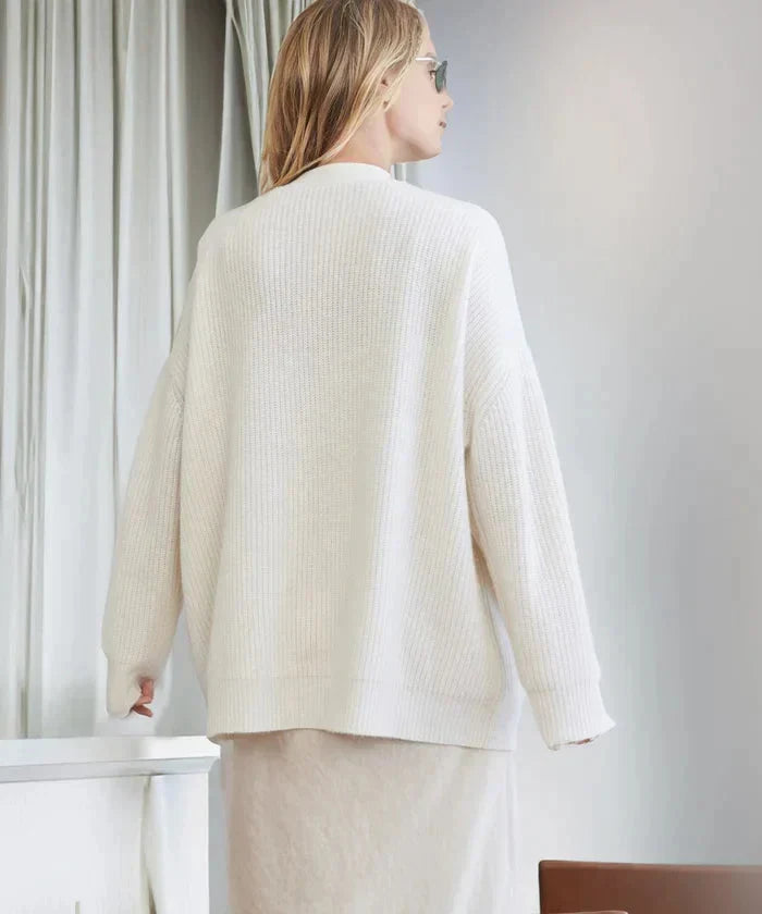 Women's black knit cardigan vest, open-front styling, showcasing its relaxed fit and elegance.
