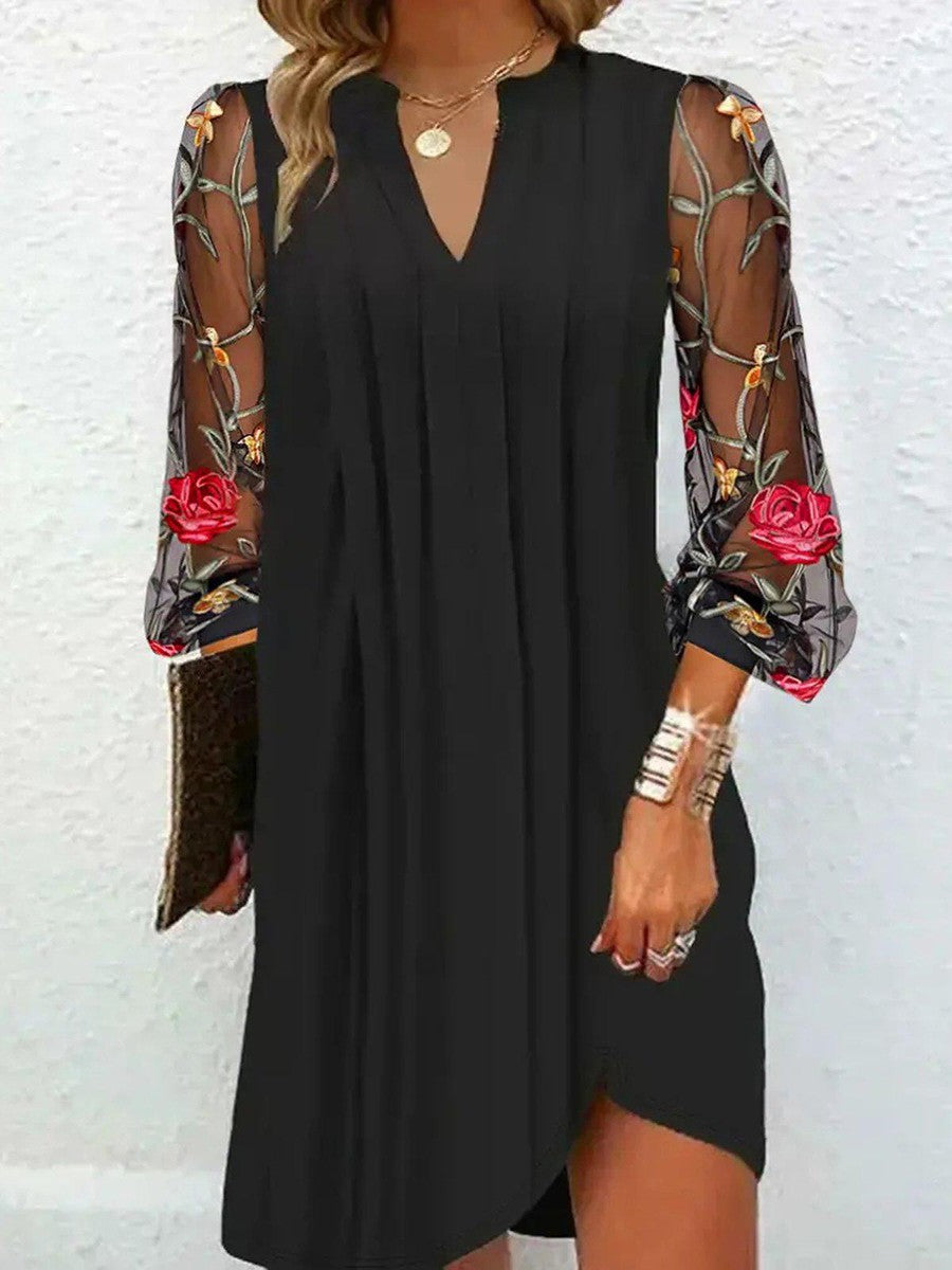 Women's elegant black V-neck dress with unique floral sleeves, a stylish formal or occasion dress.