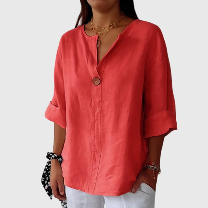 Comfortable women's long-sleeve V-neck blouse with a single button, an elegant and versatile top for any occasion.