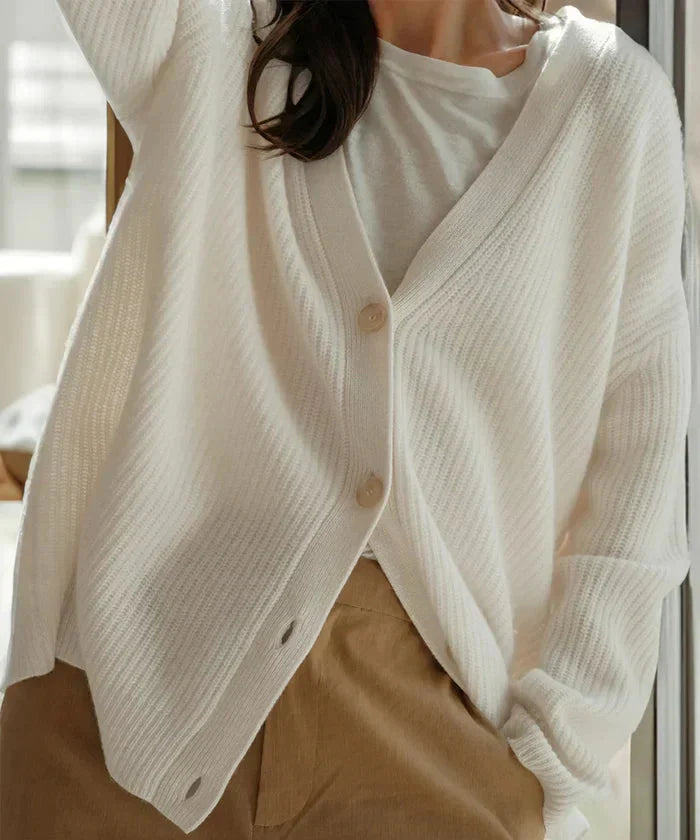 Stylish women's black button-front knit vest, ideal for modern layering and comfort.