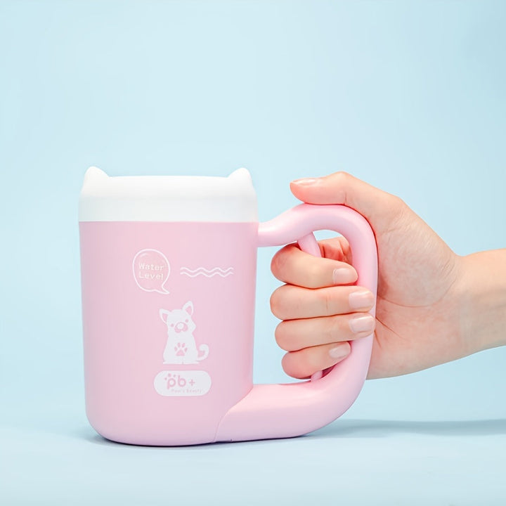 Happy dog getting muddy paws cleaned with a portable silicone paw cleaner.