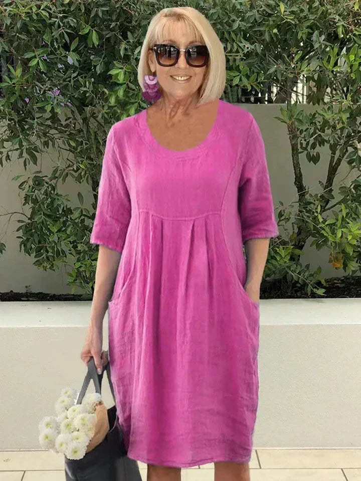 Easy-to-wear women's casual midi dress, offering a loose fit, comfortable style, & essential pockets.