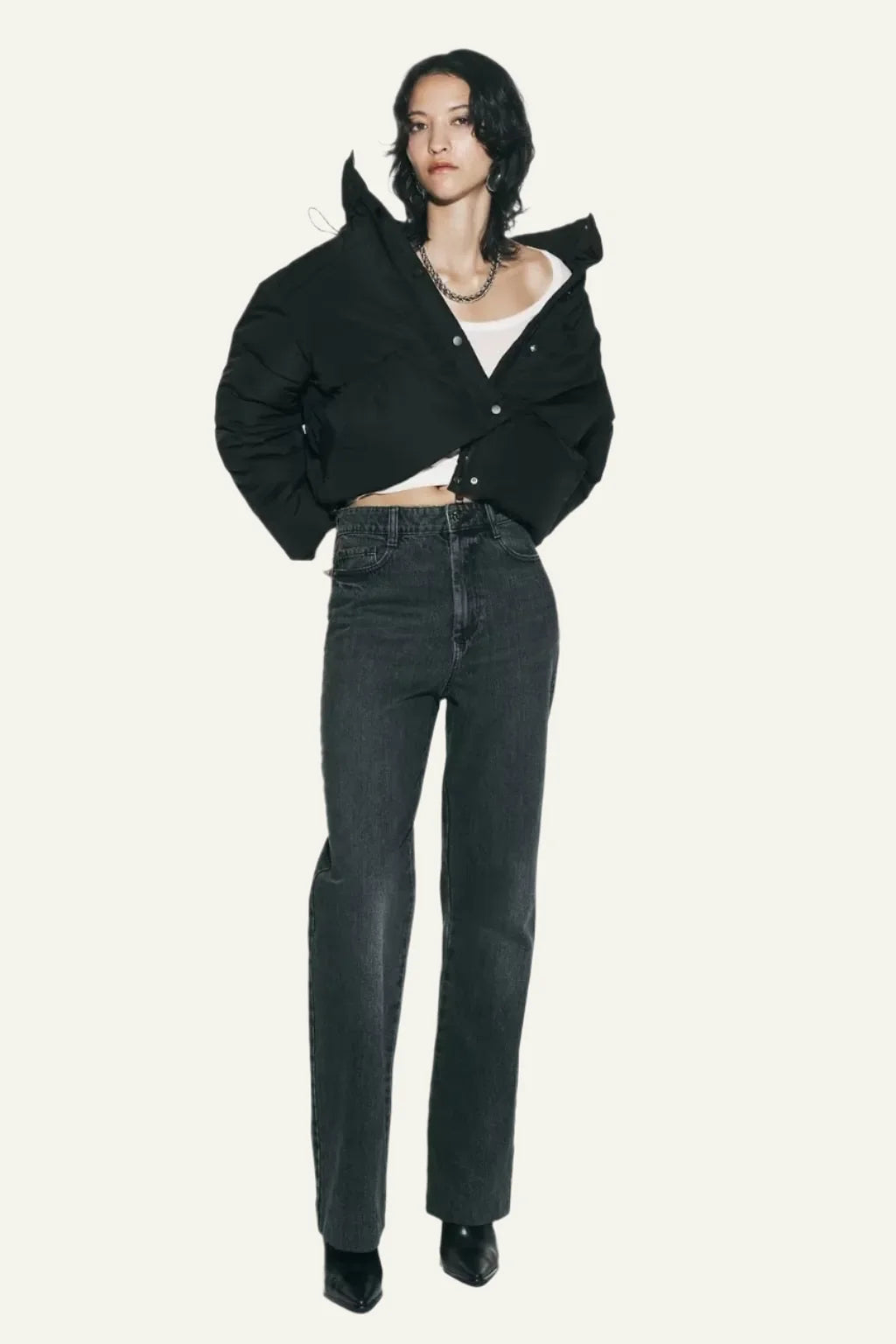Insulating black puffer jacket for women. Lightweight & warm, ideal for cold weather comfort.